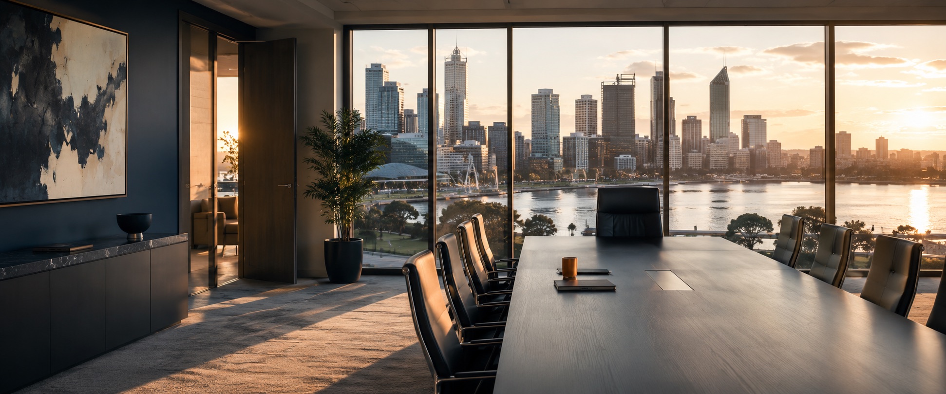 A modern boardroom overlooking the Perth skyline at sunset